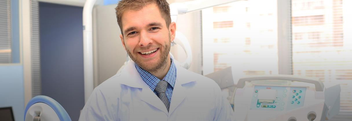 Person in a white coat smiling